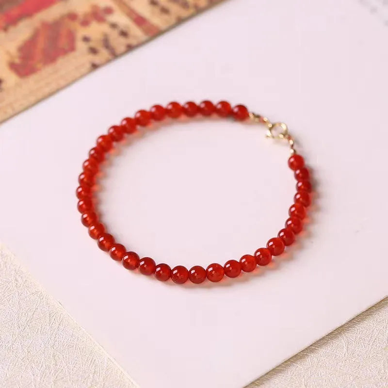A red agate bracelet for women with an ultra-thin, delicate design on a wrist.