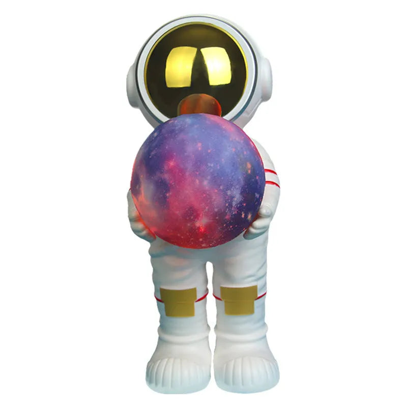 Spaceman-themed starry sky projection lamp with Bluetooth speaker on a bedside table.