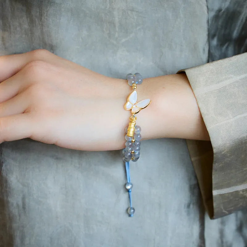 Grey moonstone bracelet with butterfly weave pattern on woven cord
