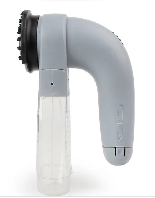 Grey portable pet hair vacuum cleaner and massage brush for dog and cat grooming on sofa