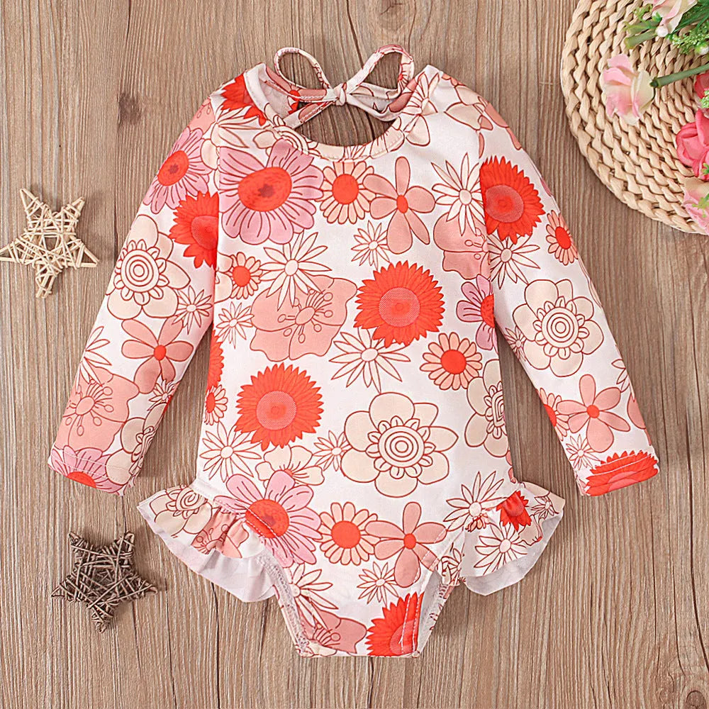 Girl's floral pattern open back swimsuit in polyester fabric showing crew neck design