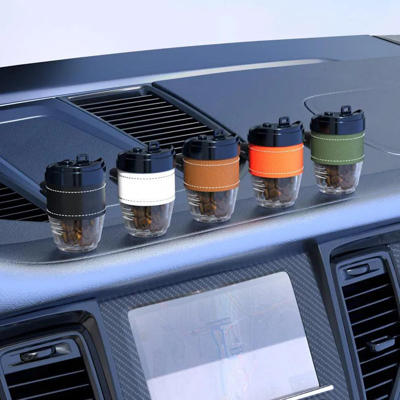 Coffee cup shaped car air freshener with solid coffee beans fragrance in brown colour on car dashboard