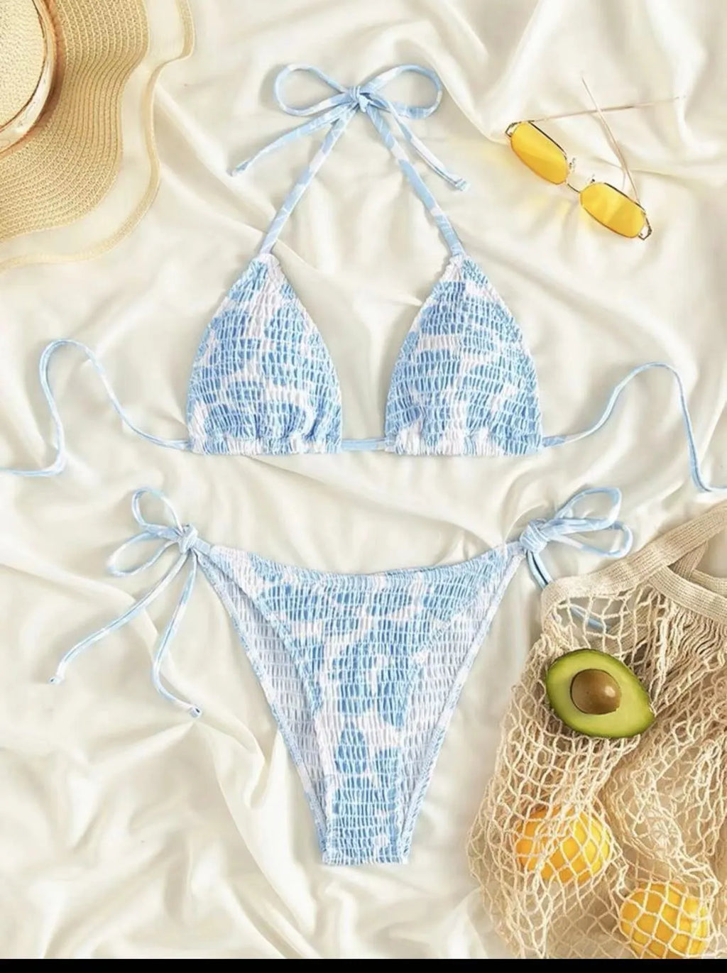 Women's floral halter swimsuit one-piece in light blue polyester on a mannequin