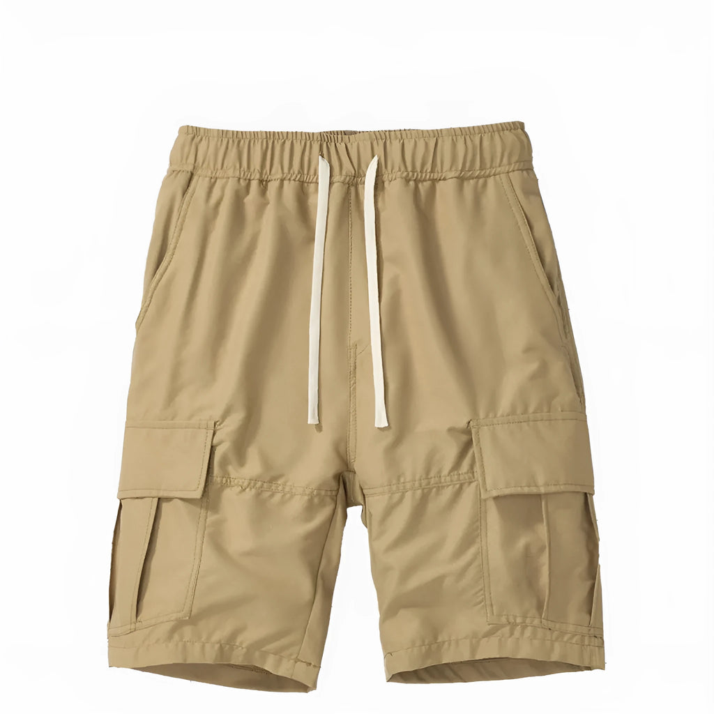 Man wearing loose black cropped pants with multiple pockets for outdoor summer leisure.