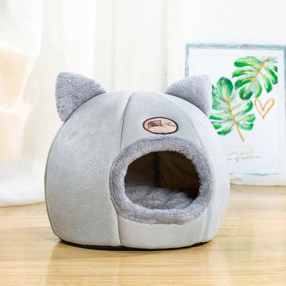 Large fully enclosed fabric cat house with a single entrance, shown in a home setting.