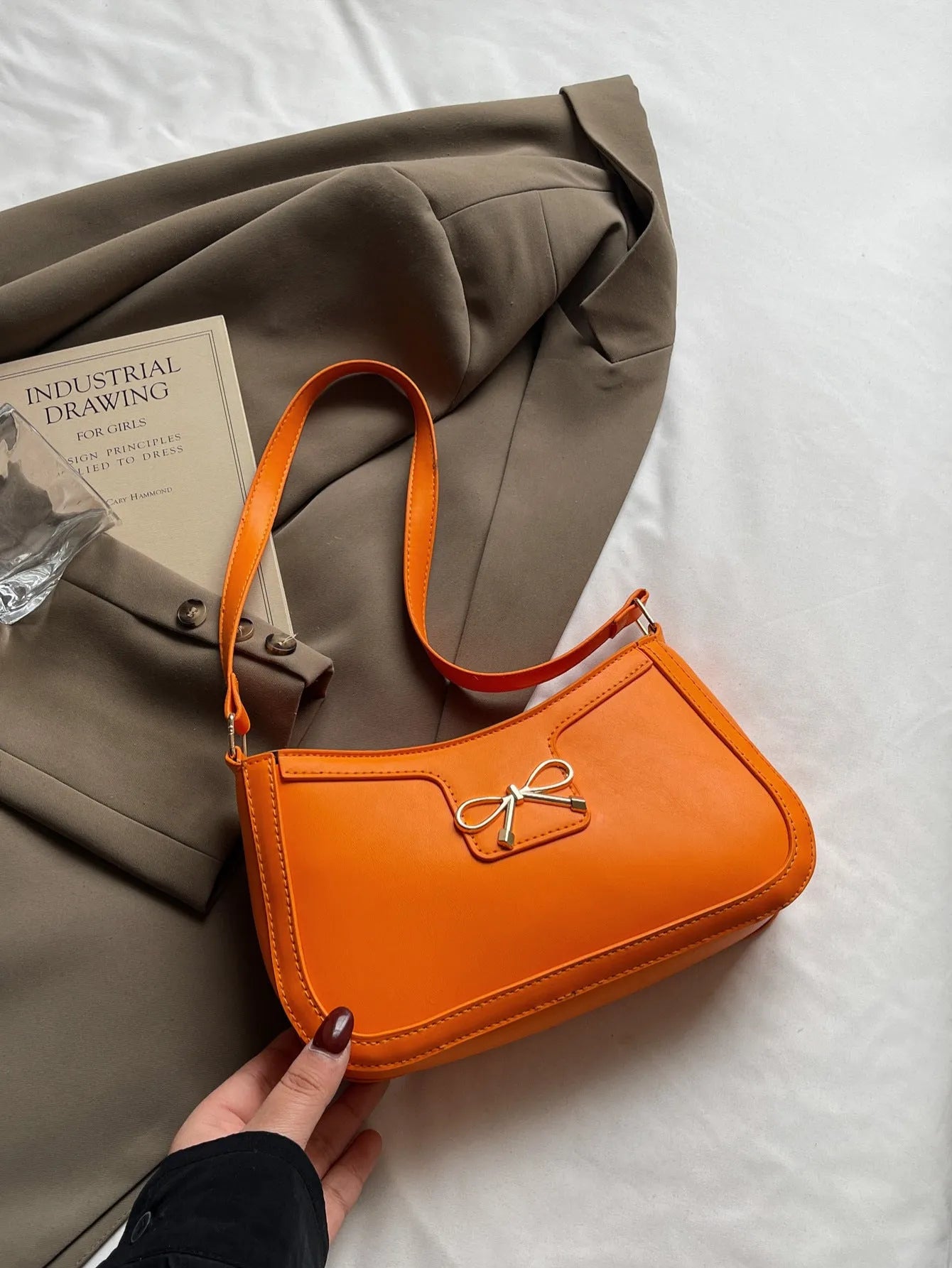 Horizontal square PU leather shoulder bag with a bow decoration, shown in multiple colours.