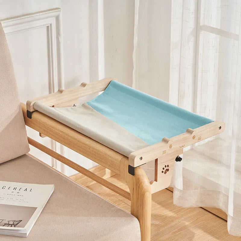 Wooden framed cat hammock bed hanging by a window, suitable for cats and small dogs.