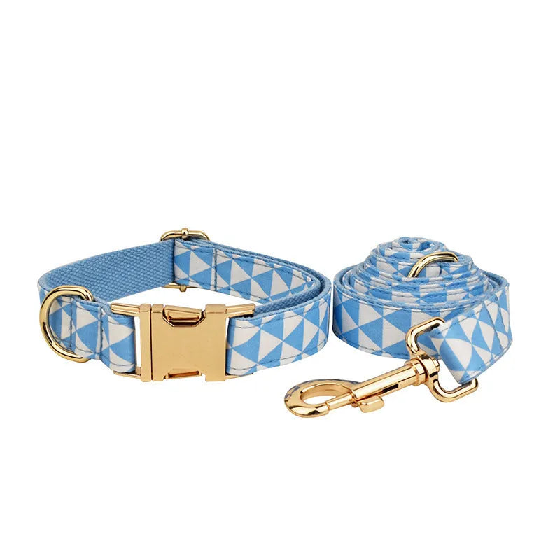 Blue triangular ring on a cloth dog collar and lead set with matching bow and vest, shown in a four-piece pet accessory package.
