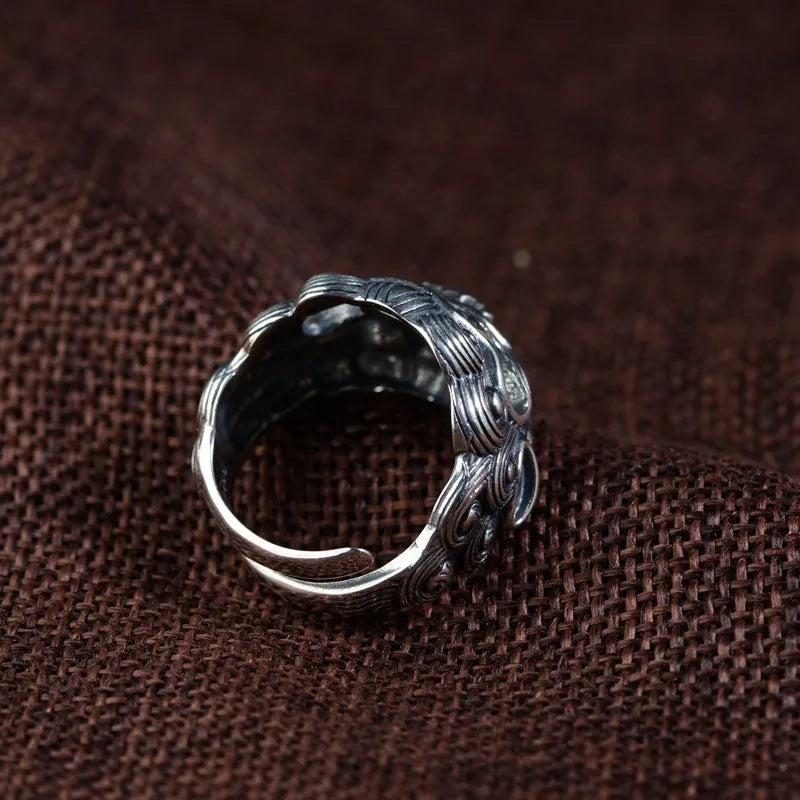 Adjustable open-style sterling silver ring with Jibeast zodiac pattern and diamond accents on finger