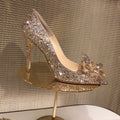 Women's gold pointed toe high heels with rhinestones and sequins on a 7cm stiletto heel