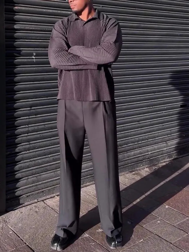 Black men's long-sleeved casual top with pleated detail on the front.