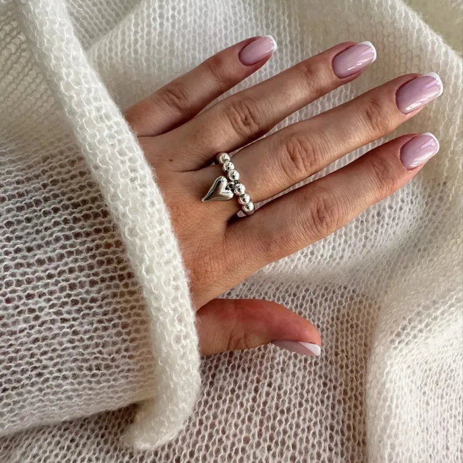 Handmade beaded elastic love ring with geometric heart design in gold and white colour options