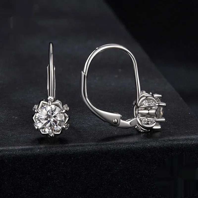 Close-up of a sterling silver floral ear clip with moissanite stone and white gold plating