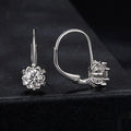Close-up of a sterling silver floral ear clip with moissanite stone and white gold plating