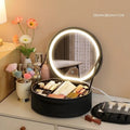 Round pink smart LED makeup bag with mirror lights open, showing internal partitions and adjustable lighting.