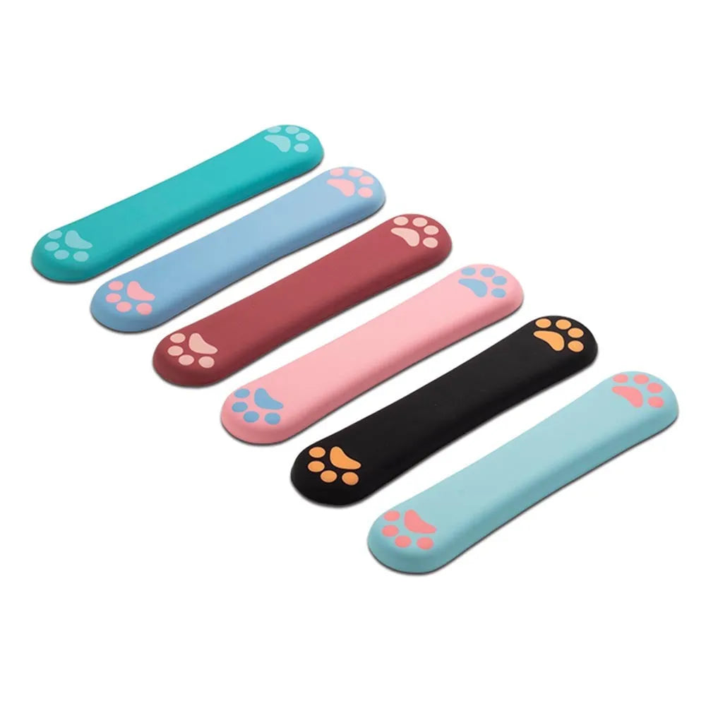 Cat's claw cartoon design memory foam keyboard wrist rest pad in blue, showing its length and thickness on a desk.