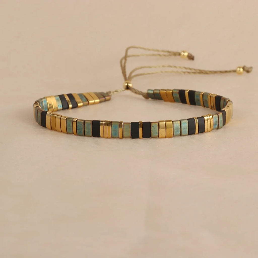 Geometric glass beads bracelet in five colour options showing 8mm beads and secure clasp on wrist