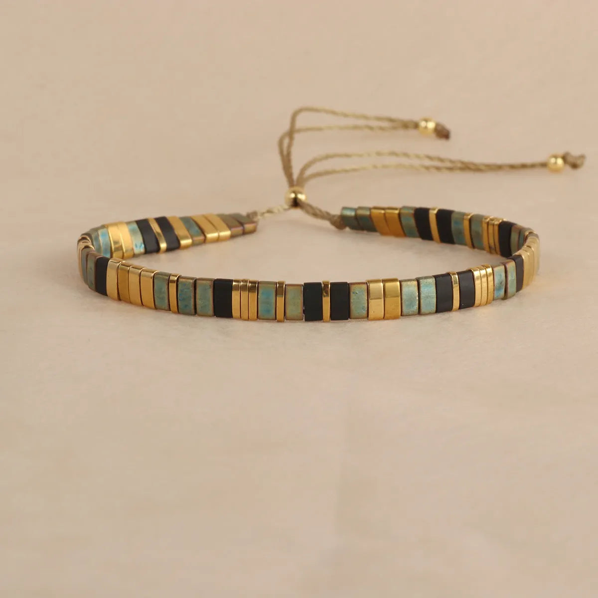 Geometric glass beads bracelet in five colour options showing 8mm beads and secure clasp on wrist