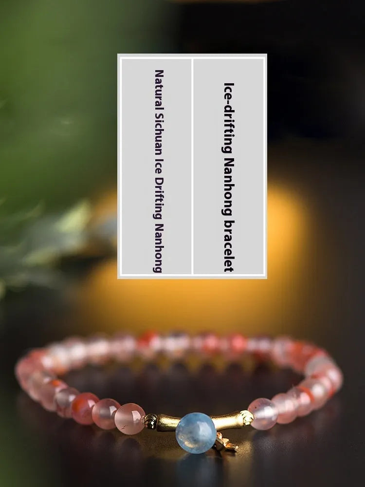Close-up of a handmade nanhong agate bracelet with a flower design and bamboo joint detail.