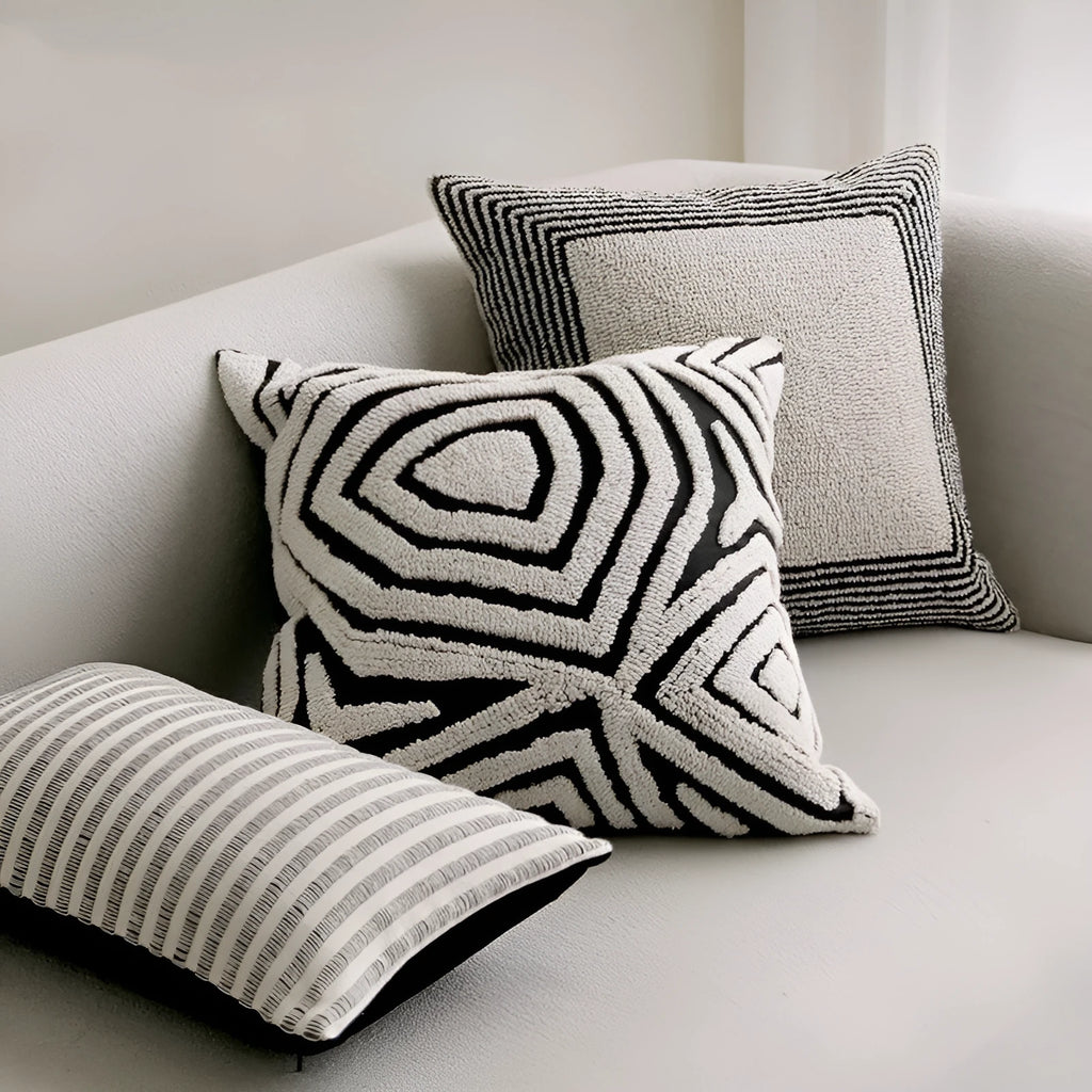 Black and white geometric patterned square and waist living room cushions with towel embroidery.