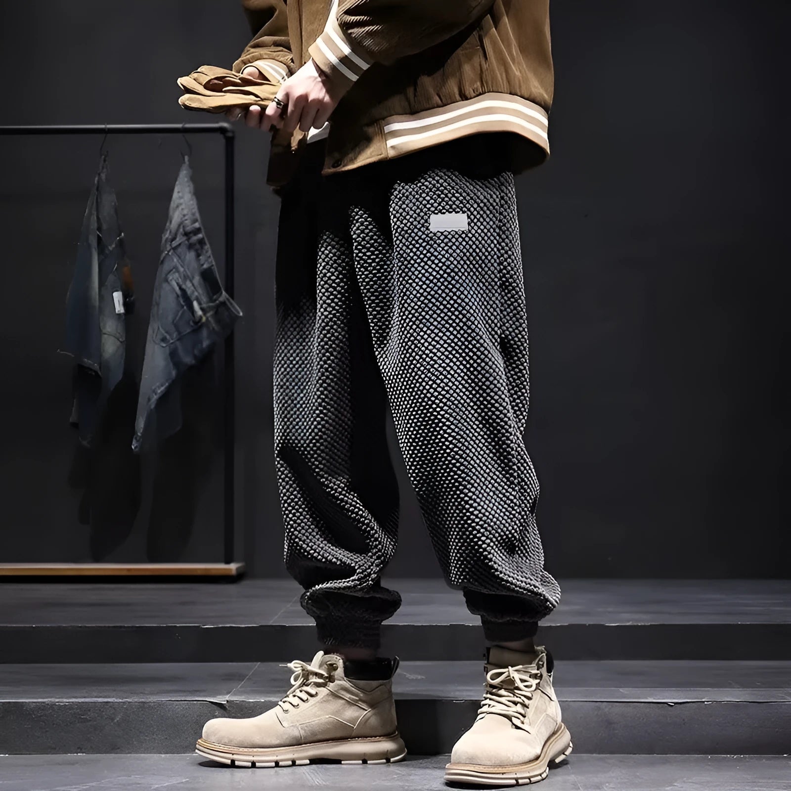 Man wearing grey ankle-tie sweatpants, showing the straight leg and adjustable cuff detail.