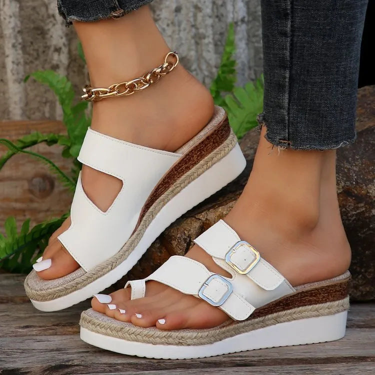 White patent leather women's wedge sandals with finger-fit woven design and peep toe.
