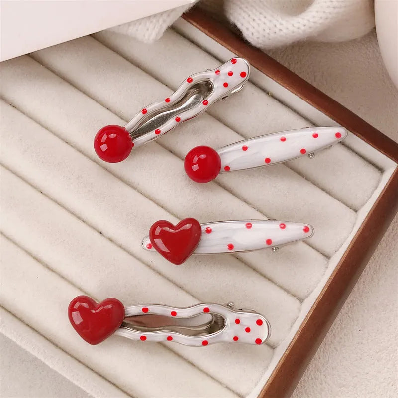 Red three-dimensional love heart-shaped hair barrette with retro dots and a willow leaf design.
