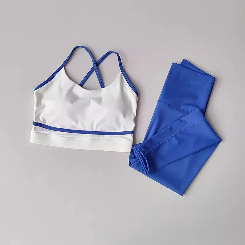 Women's blue and white quick-drying nylon spandex yoga set with sleeveless tank top and cropped pants.