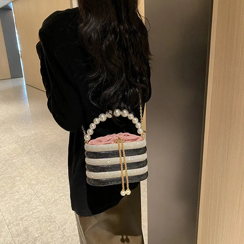 Women's round crossbody bag in soft PU with beaded details, adjustable strap, and zippered interior organiser.