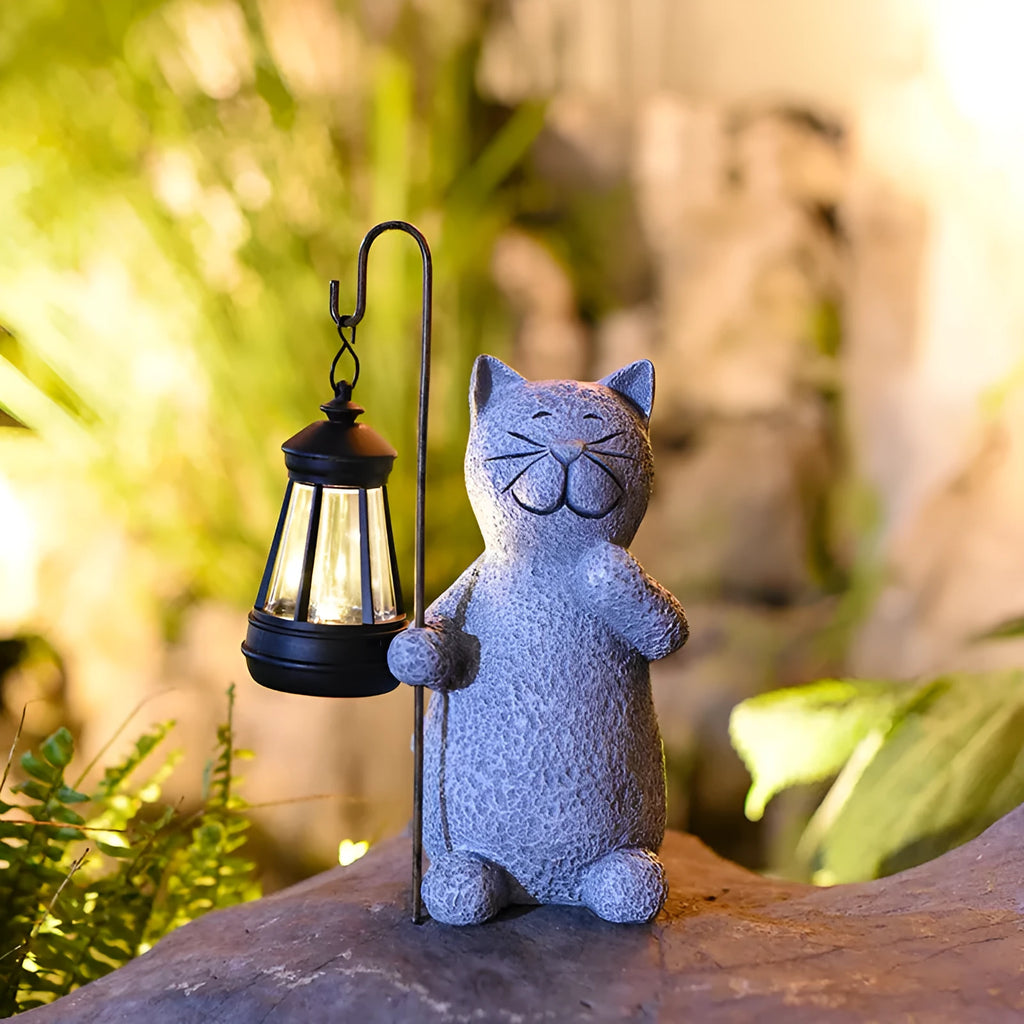 Solar garden light featuring a resin sculpture of a kitten holding up a lantern.