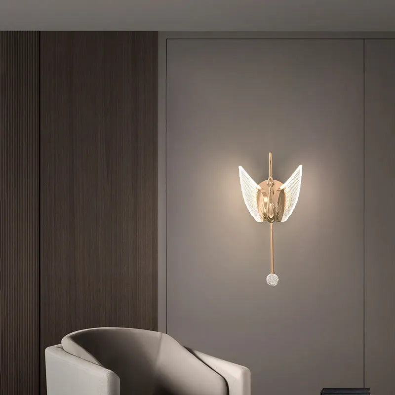 Gold swan-shaped wall lamp with acrylic shade and iron body, mounted beside bed with adjustable LED lighting