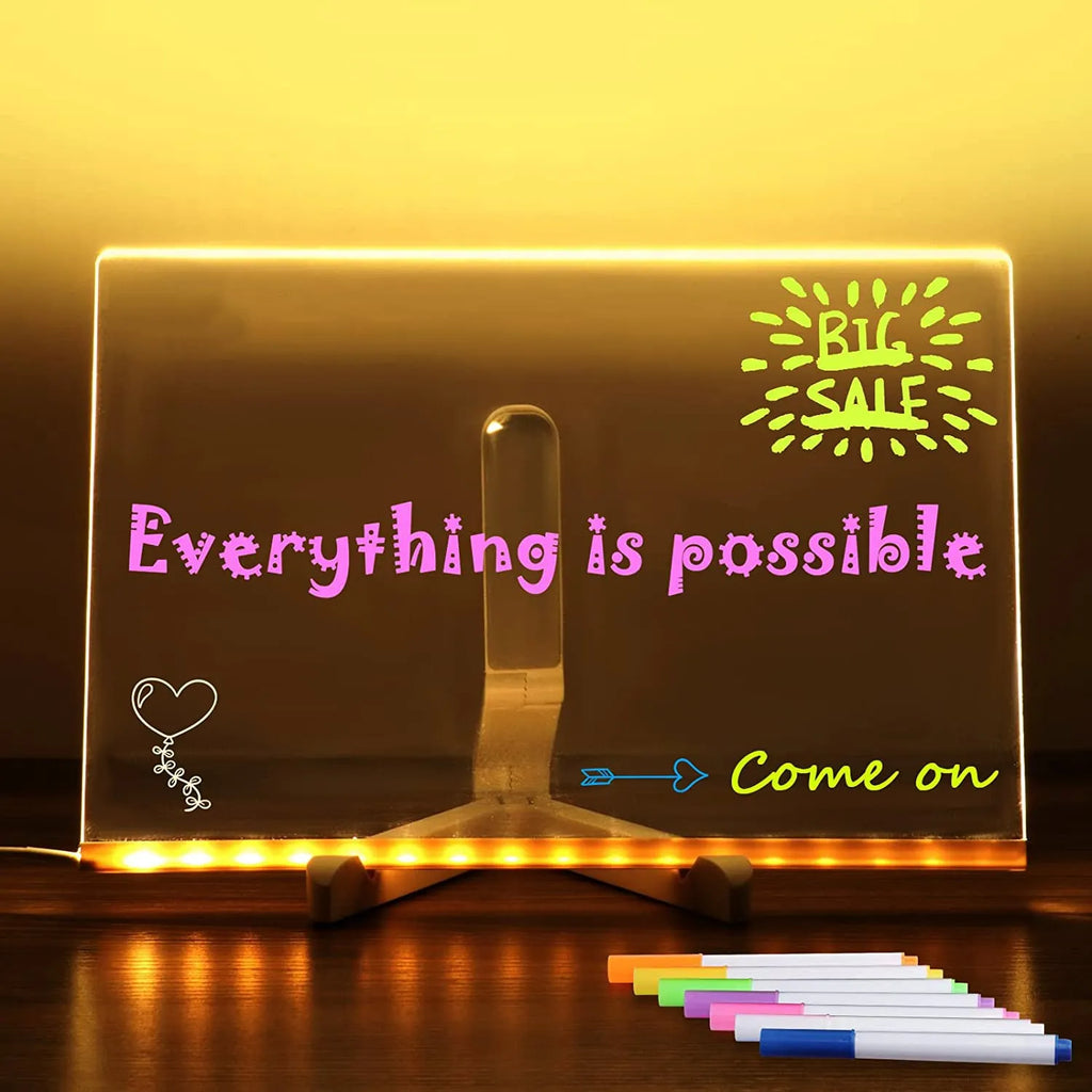 Acrylic DIY LED message board night light on a desk with handwritten drawing glowing softly.