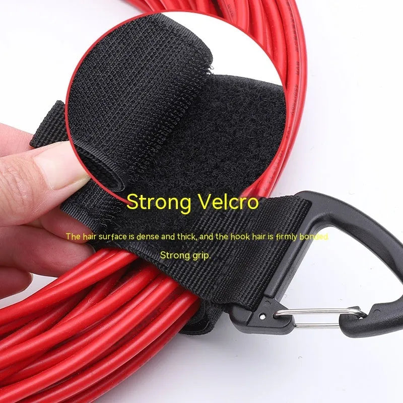 Black gravity storage strap with metal carabiner hook for workshop and camper organisation