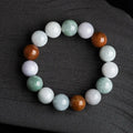 Women's Myanmar jade bracelet with 13mm round beads showing three natural jade colours