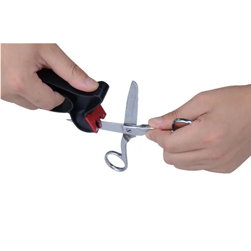 Black handheld tungsten steel knife and scissor sharpener on a kitchen counter