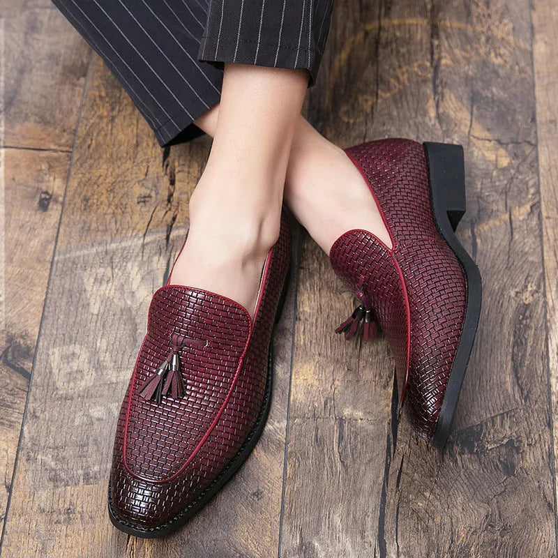 Men's black pointed slip-on leather shoes with tassel detailing on a low-top upper for business wear