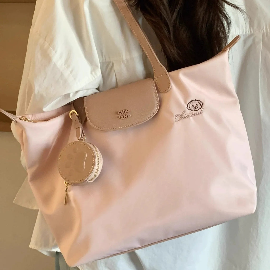 Pink Oxford cloth tote bag with sandwich pocket and shoulder strap showing sewing thread detailing