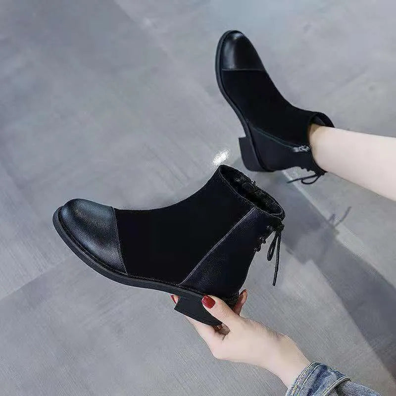 Black women's Martin boots with non-slip rubber soles and side zipper, showing round toe and short stout heel.