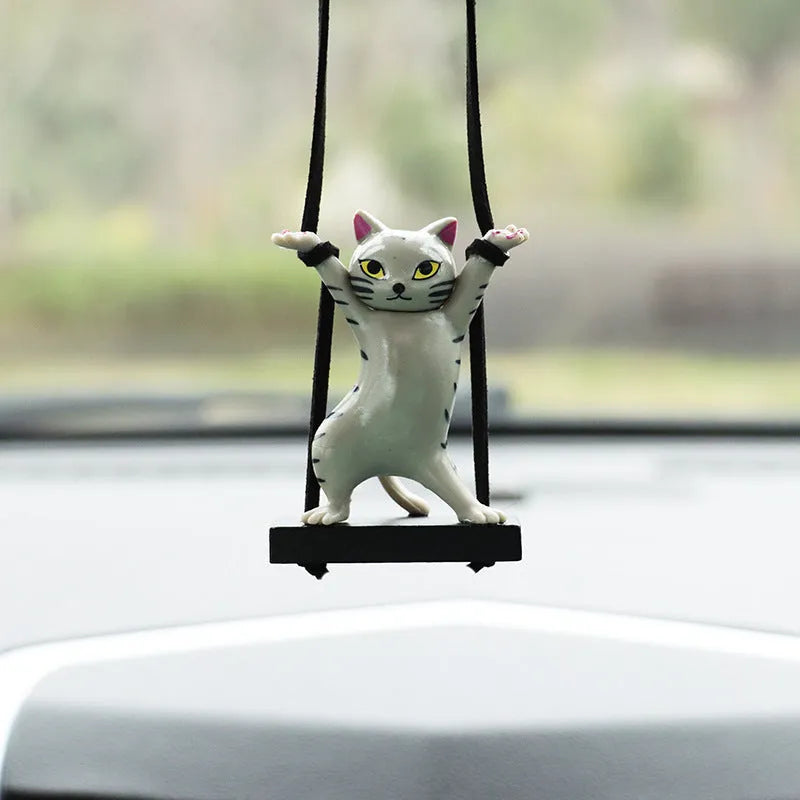 Cartoon-style resin cat pendant for car interior decoration in various colours with adjustable rope.