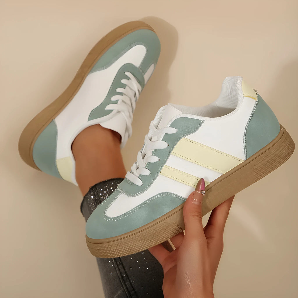 Women's low-top retro sports pumps in a candy colour with cross-strap detail on artificial PU upper.