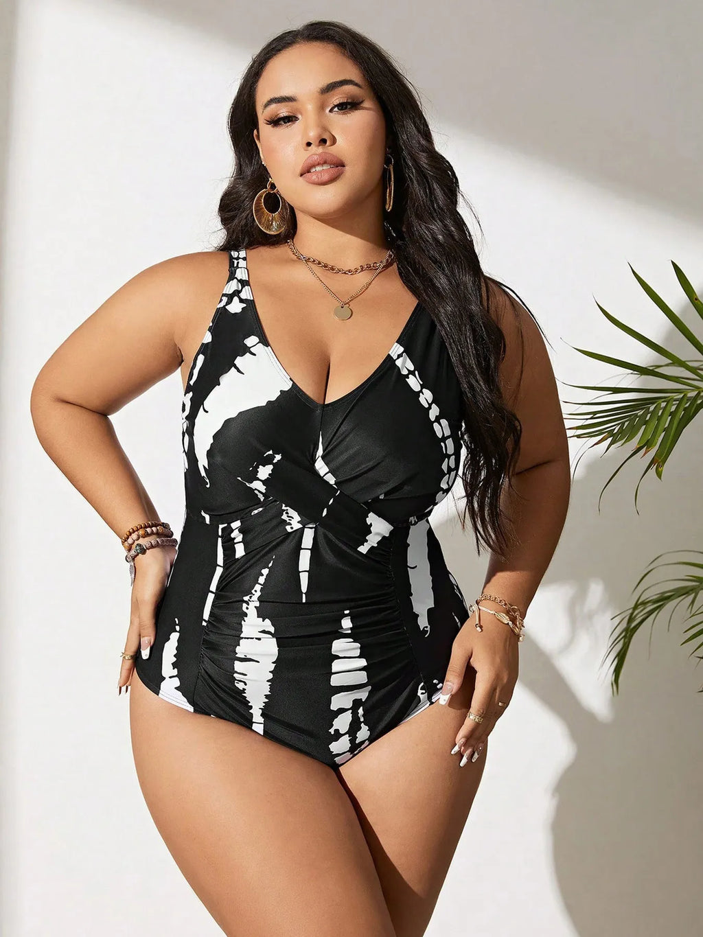 Black plus size one-piece swimsuit on a hanger, showing sleeveless conservative design.