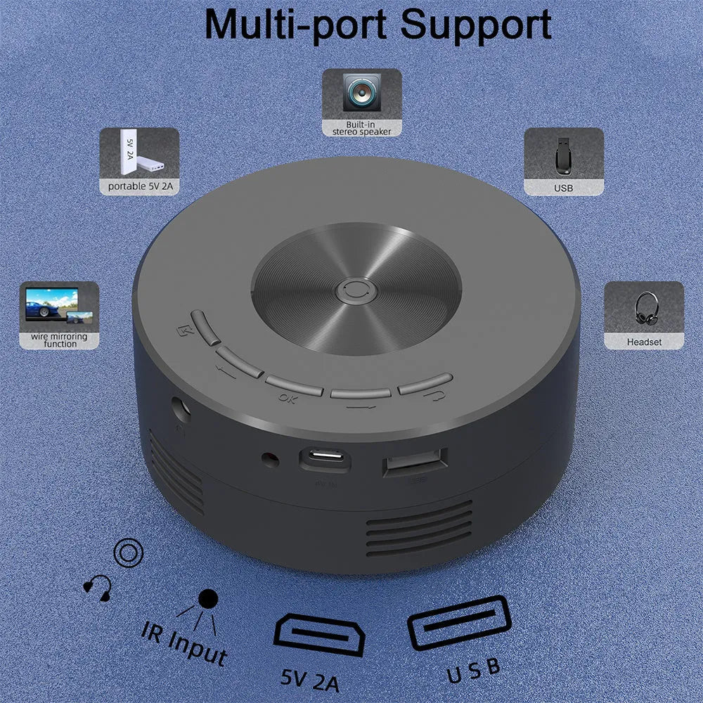 Black portable mini projector for children next to a smartphone for scale