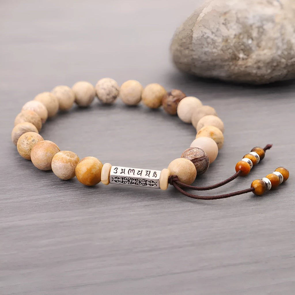 Handmade natural stone bead bracelet in a wood tone colour on a white background.