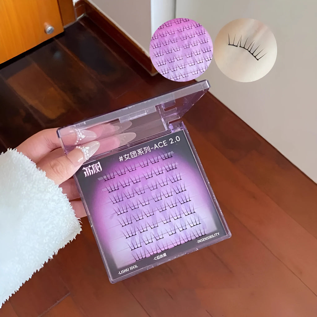 Pack of reusable false eyelash clusters made from black artificial fibre on a clear plastic tray.