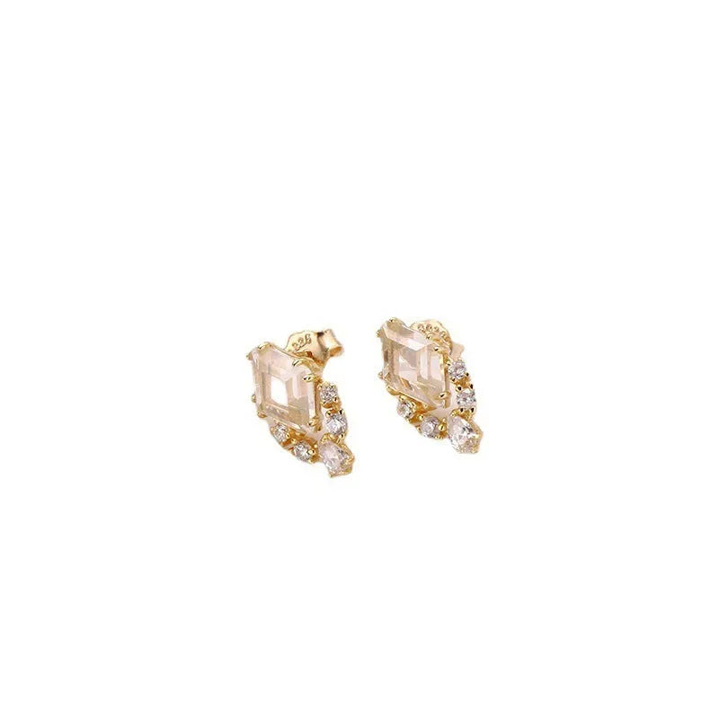 Geometric silver earrings with sweet white crystal studs showing structured design