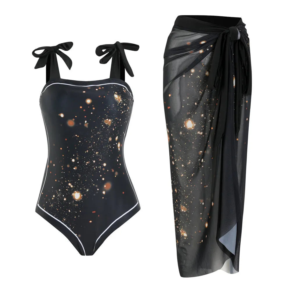 Floral print one-piece swimsuit with mesh tube top and a matching detachable skirt laid flat.