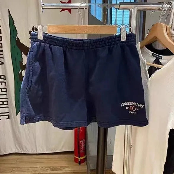 Women's dark blue cotton sports shorts with white flag embroidery and free size fit for athletic activities
