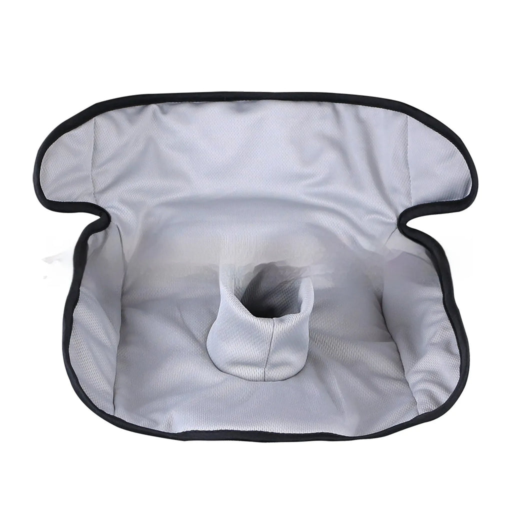 Alien-shaped grey car seat protective pad with urine-separation layer on a car seat.