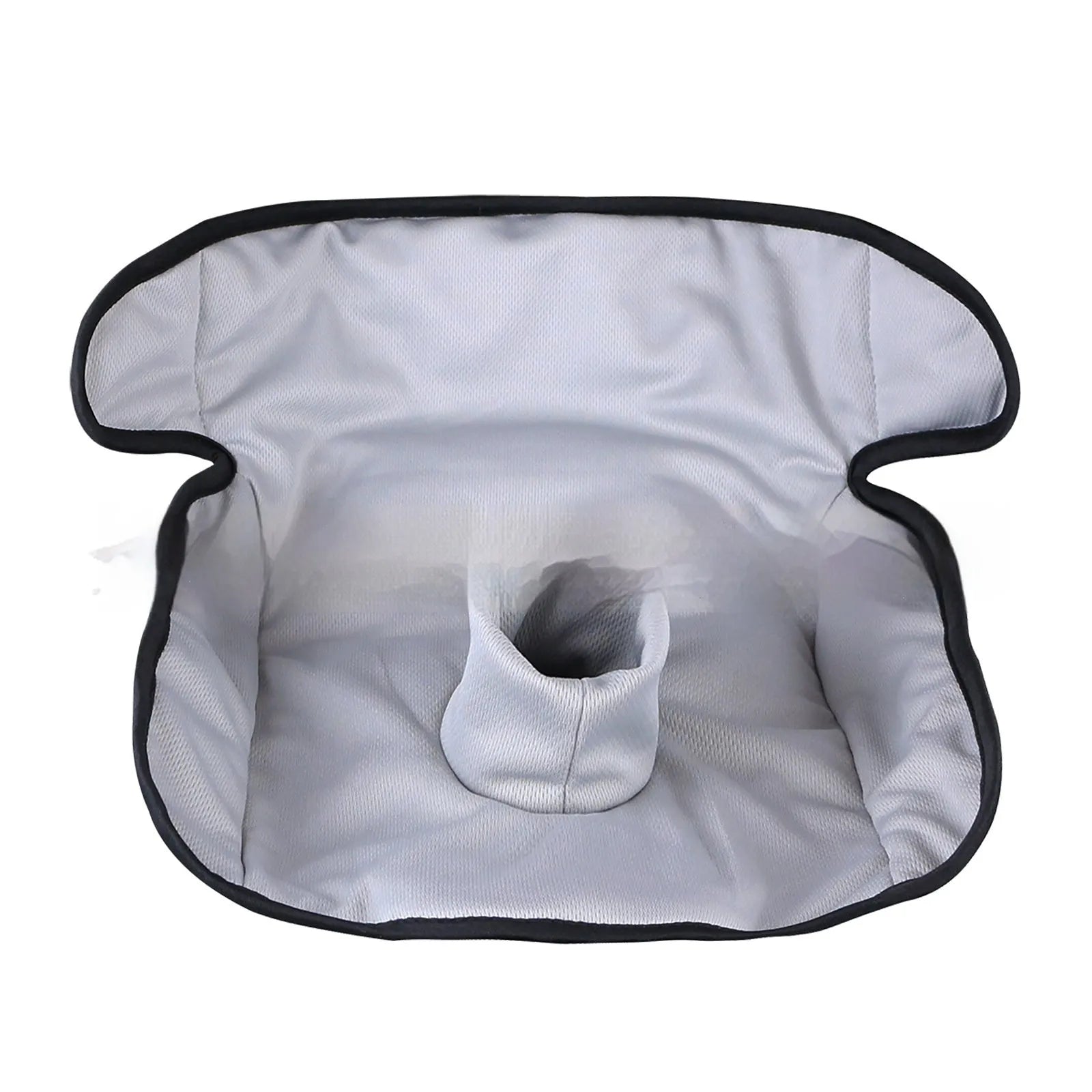 Alien-shaped grey car seat protective pad with urine-separation layer on a car seat.