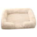 Plush round dog bed in beige brown with raised sides and a removable inner sleeve.